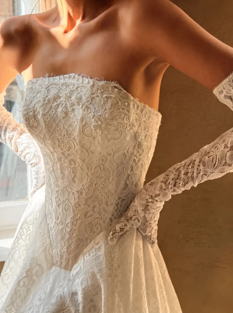 Milla nova Amalia is a dropped basque waist Aline lace wedding dress in corded chantilly lace with matching gloves