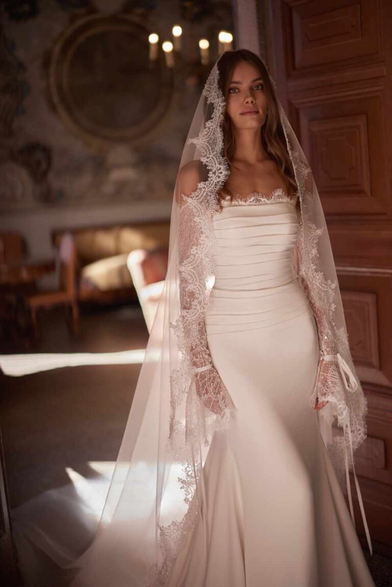 Monet by ivory bridal is now at Wedding Belles of Four. She is a stunning draped crepe satin fitting dress with chantilly long lace sleeves matched with a mantilla lace veil