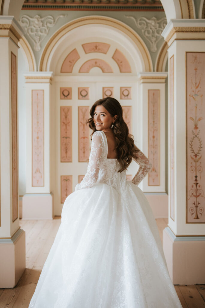 Monroe by Lottie and Meg from Wedding Belles of Four Oaks. This long sleeve dramatic ballgown with lace and beadwork detail has a stunning square neckline